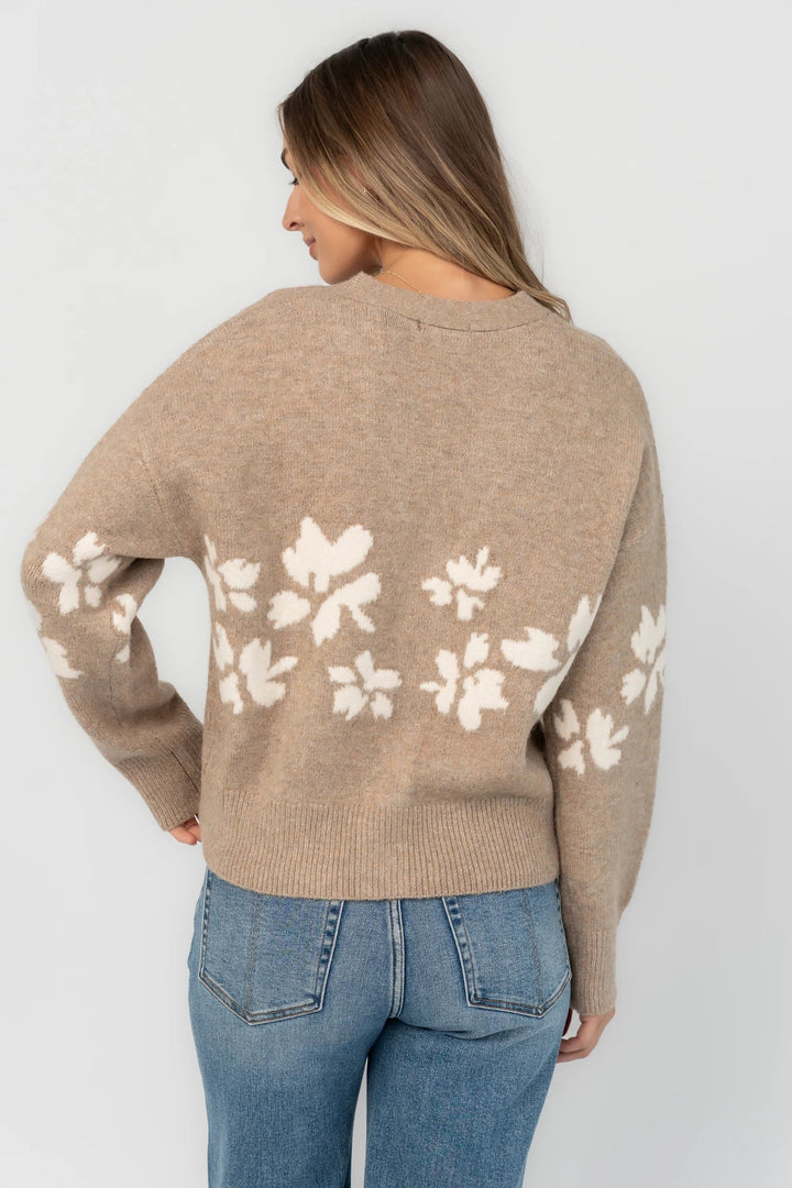 Taupe floral knit cardigan with a V-neckline, button-front closure, long sleeves, ribbed trim, and a relaxed silhouette.